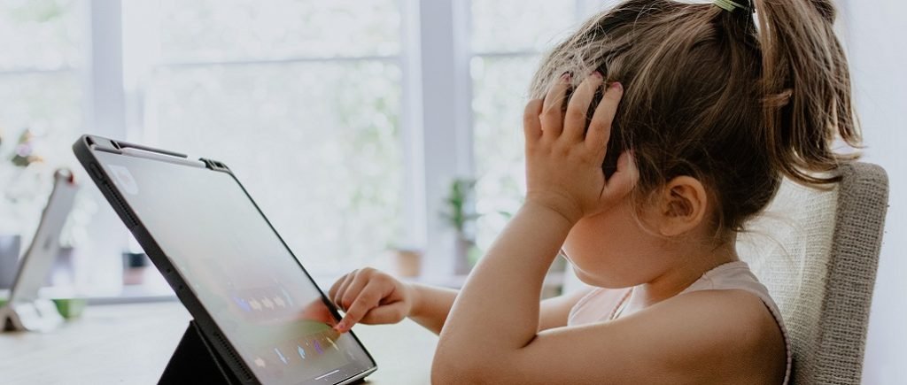 Girl using tablet being aware of online safety
