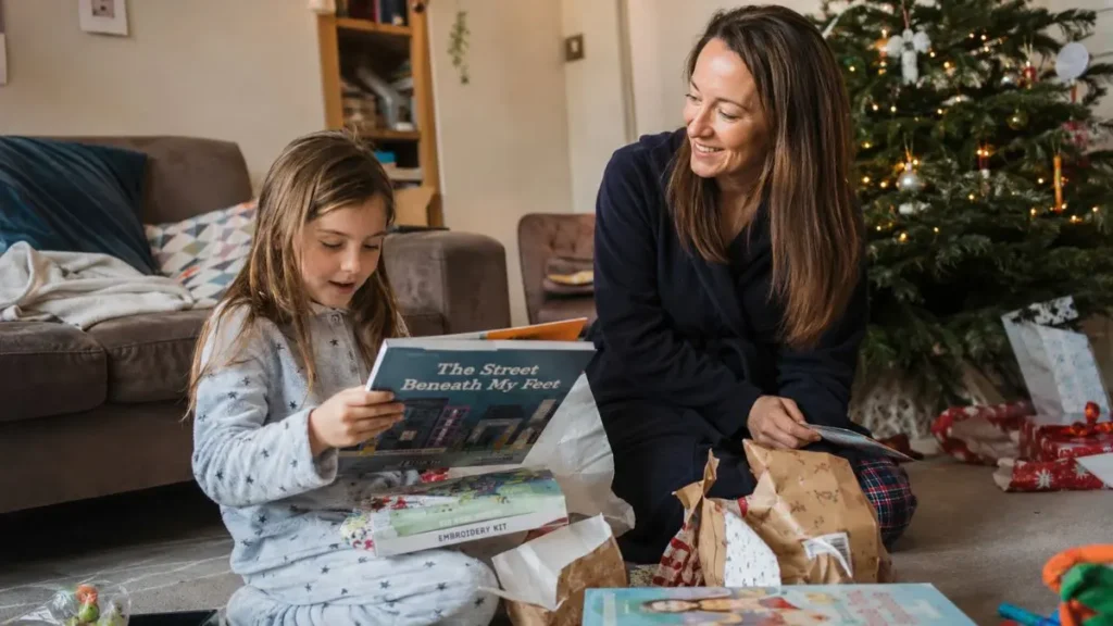 Child opening thoughtful non-toy Christmas gifts in a UK family home.